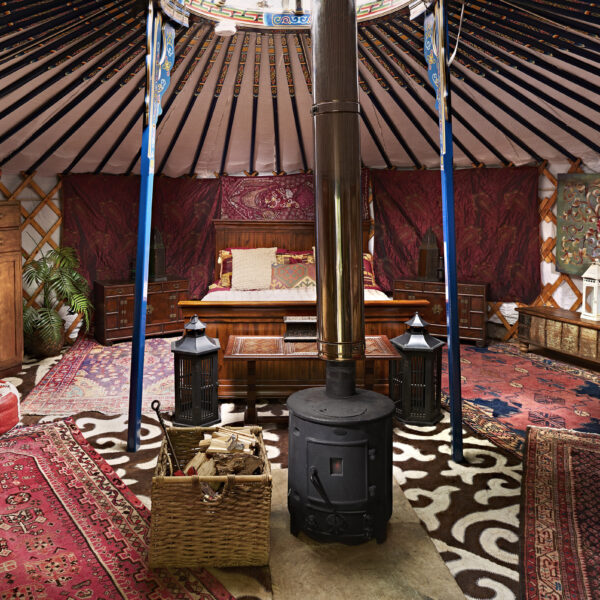 Wood stove inside a large yurt.